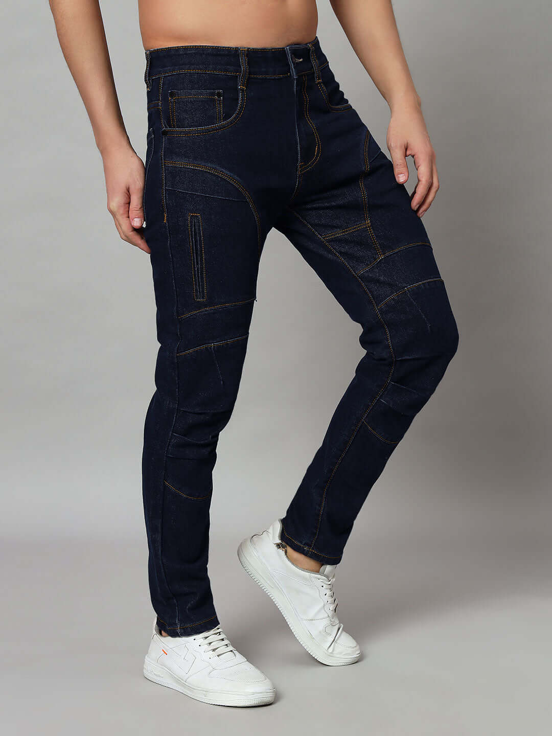 Person wearing NOVICE contrast stitch denim jeans in blue with white sneakers, showcasing made-to-order craftsmanship.