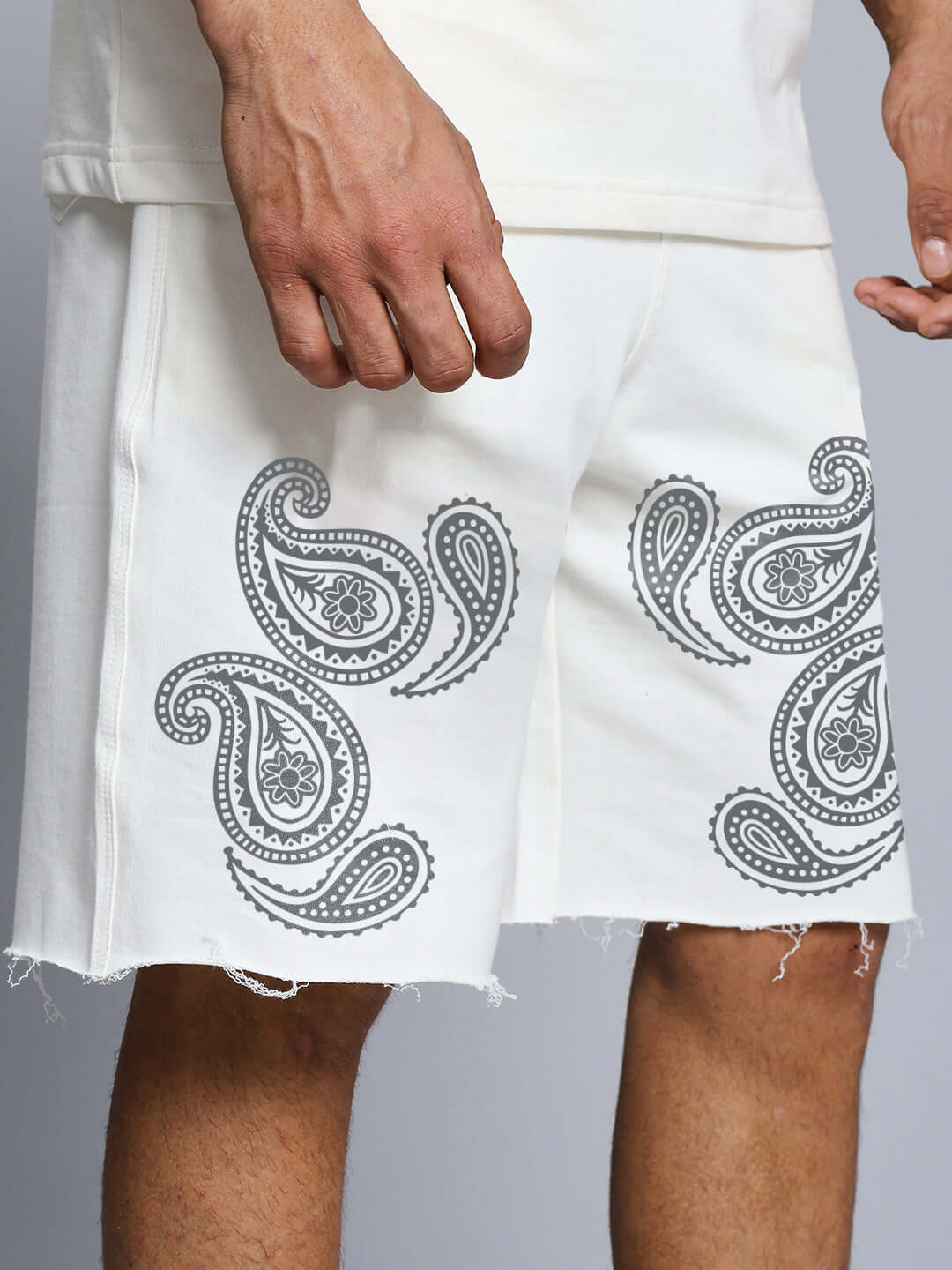 Man wearing MESSI PAISLEY PRINT CO-ORD SET OFF WHITE shorts with paisley design