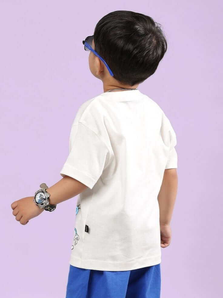 Child wearing the OGGY PRINTED T-SHIRT FOR BOYS AND GIRLS OFF WHITE, showcasing the back design and fit.