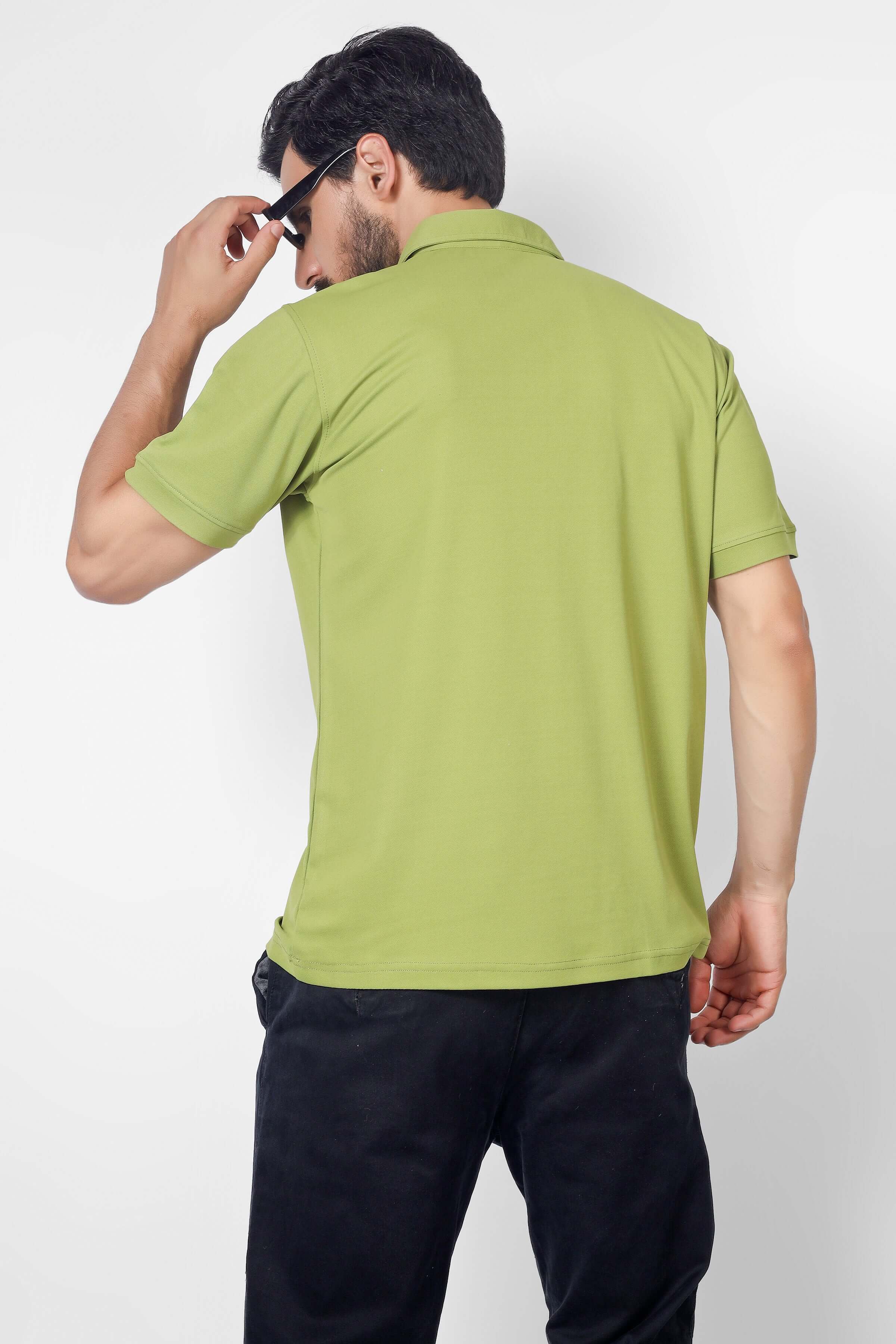 Back view of a man wearing an olive green polo neck T-shirt with half sleeves, made of wrinkle-free, quick-dry polyester fabric.