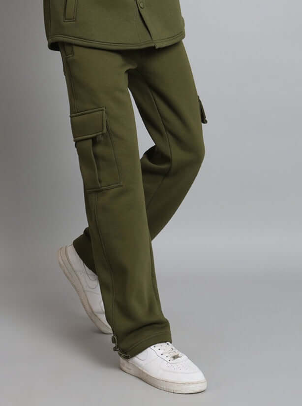 Olive green relaxed fit fleece cargo pants with pockets, paired with white sneakers, showcasing casual and comfortable style.