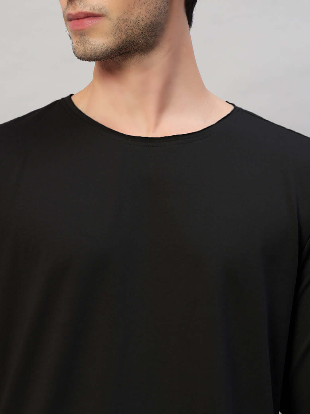Model wearing OMNI Slim Fit Black Sweatshirt in premium cotton fabric, showcasing minimalistic design and smooth texture.