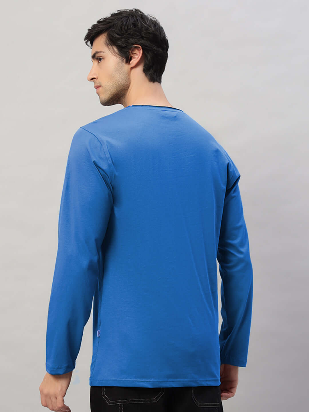 Model wearing OMNI slim fit blue sweatshirt made from premium cotton, showcasing back view with long sleeves and casual style.