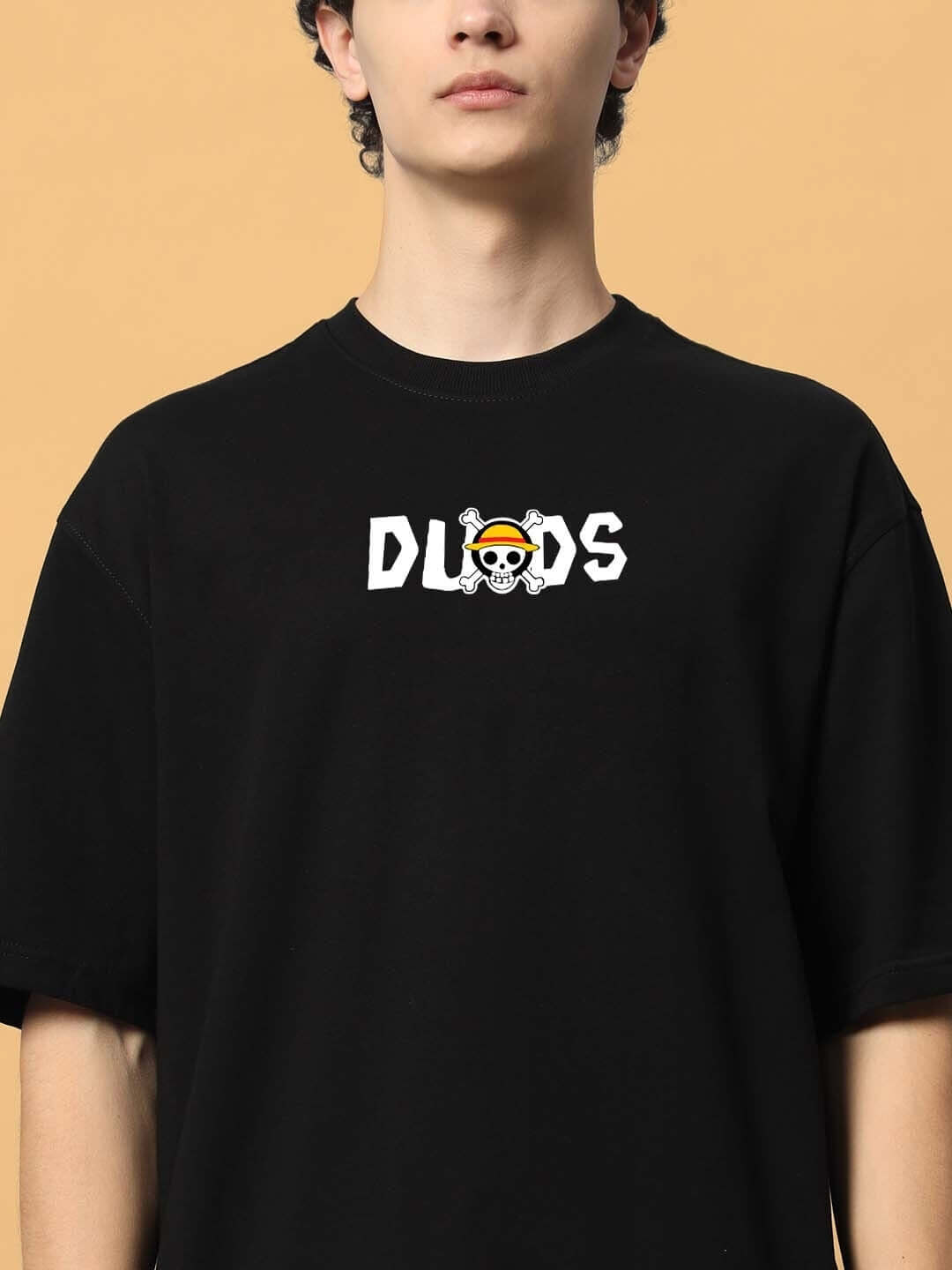 Model wearing black oversized One Piece t-shirt with DUDS logo