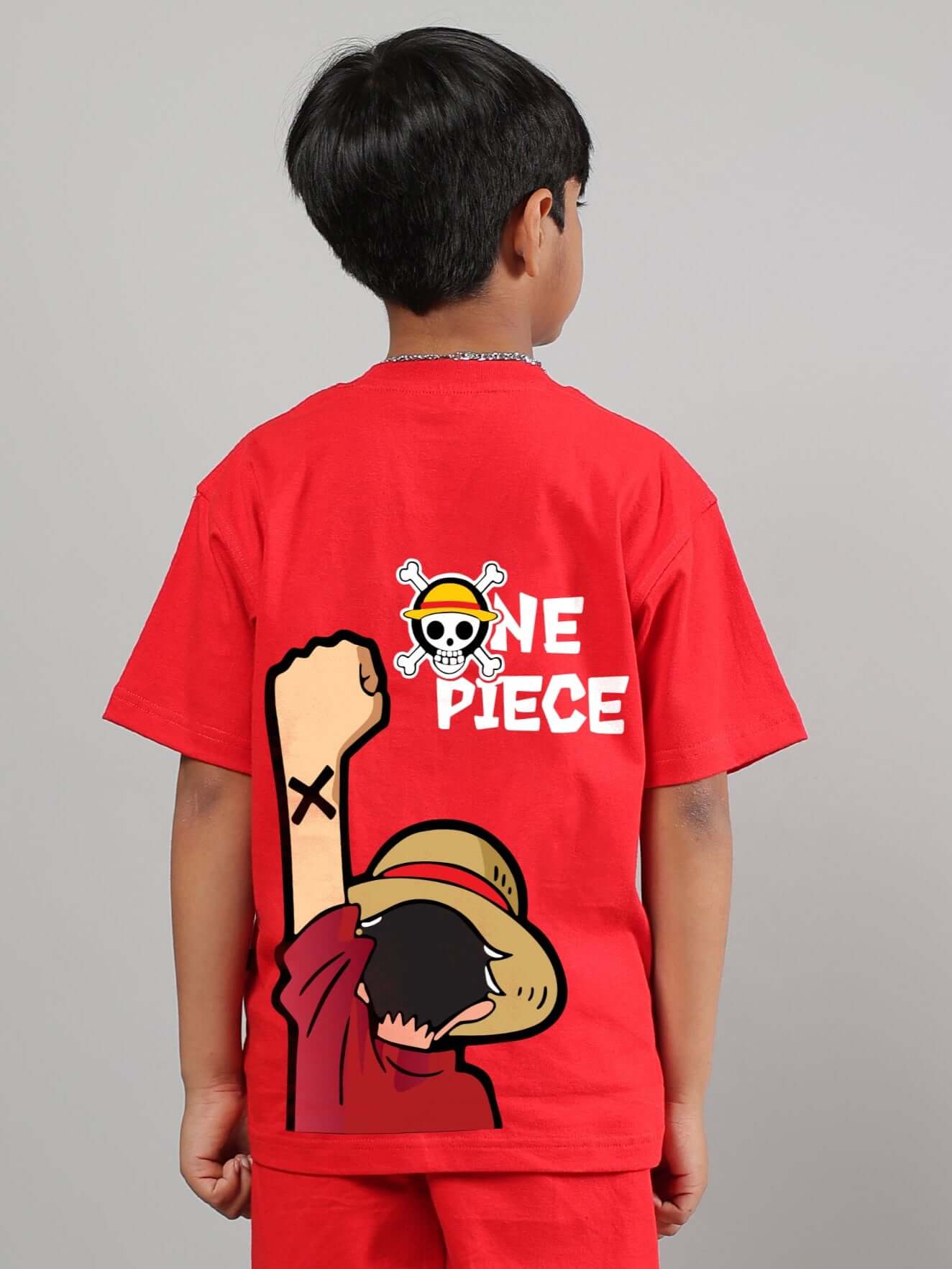 Child wearing red One Piece t-shirt featuring Luffy design for boys and girls.