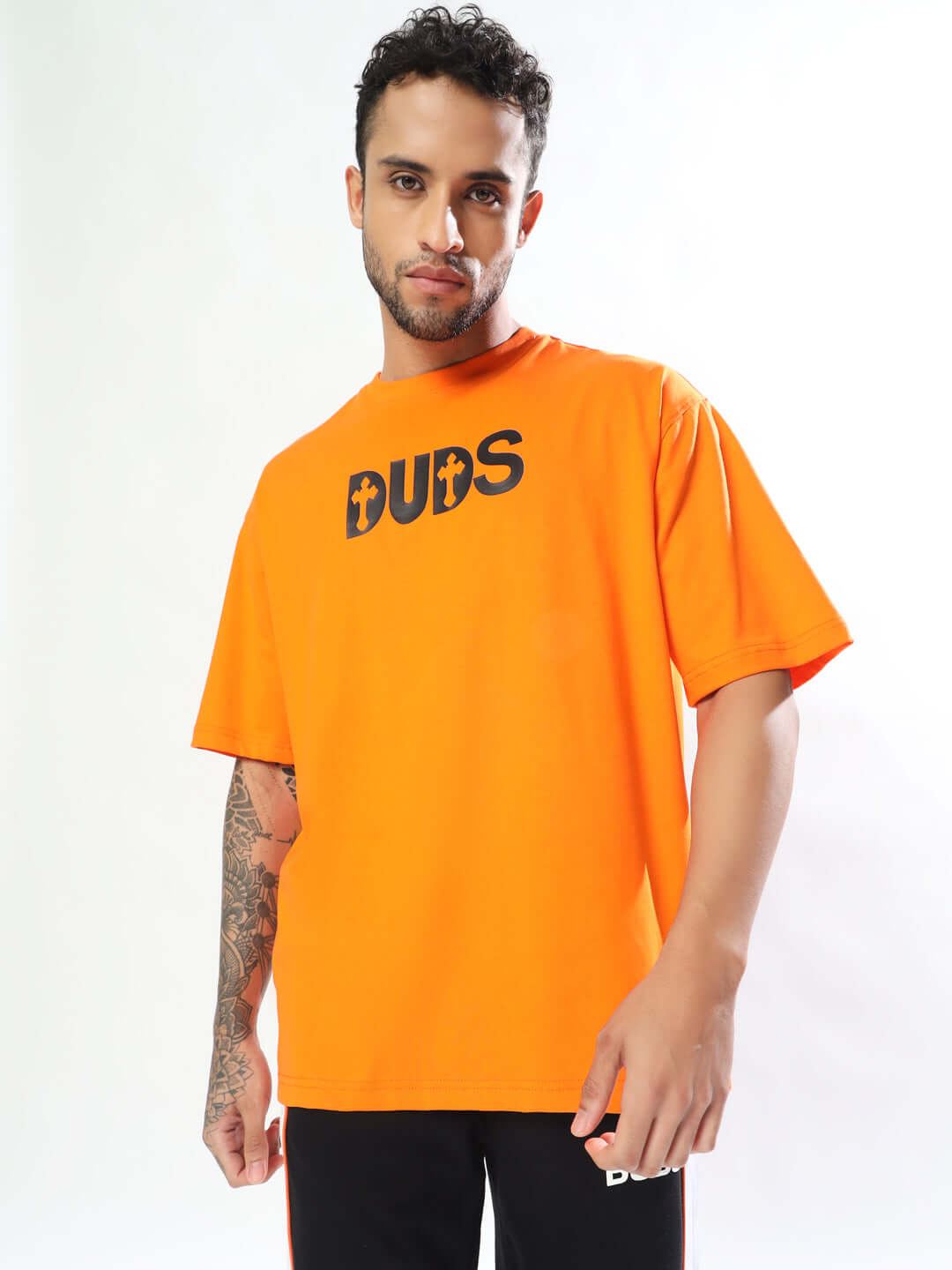 Model wearing orange oversized T-shirt with 'ONLY GOD CAN JUDGE ME' text, made of premium cotton French terry, perfect for casual wear.