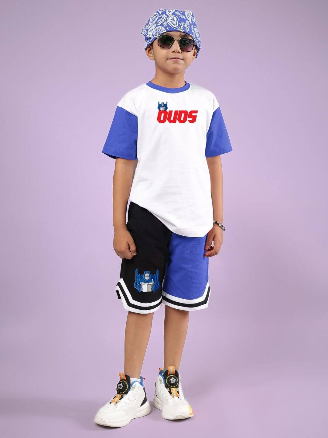 Child wearing OPTIMUS PRIME CO-ORD FOR BOYS & GIRLS WHITE BLUE outfit with shorts and t-shirt by DUDS, suitable for both boys and girls.