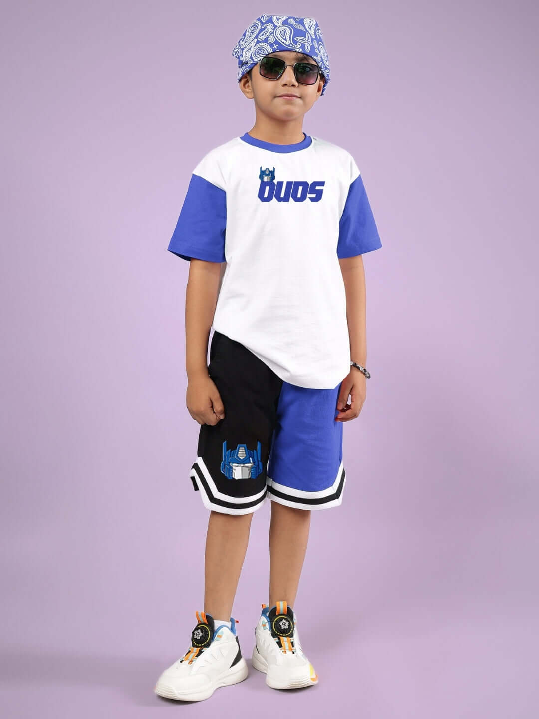 Boy wearing Optimus Prime Shorts for Boys & Girls Black-Blue, showcasing Transformers design and style.