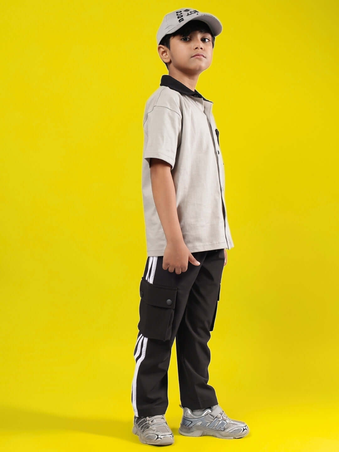 Child wearing ORION CO-ORD FOR BOYS & GIRLS GREY-BLACK with a yellow background, displaying stylish apparel.