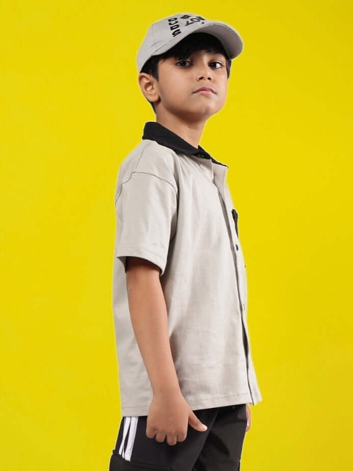 Child wearing ORION grey-black shirt, side view