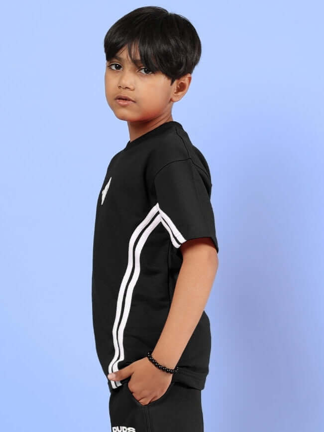 Boy wearing OUTLOOK T-SHIRT FOR BOYS GIRLS BLACK with striped detail on side, casual kids streetwear style, sleek black for versatile fashion.