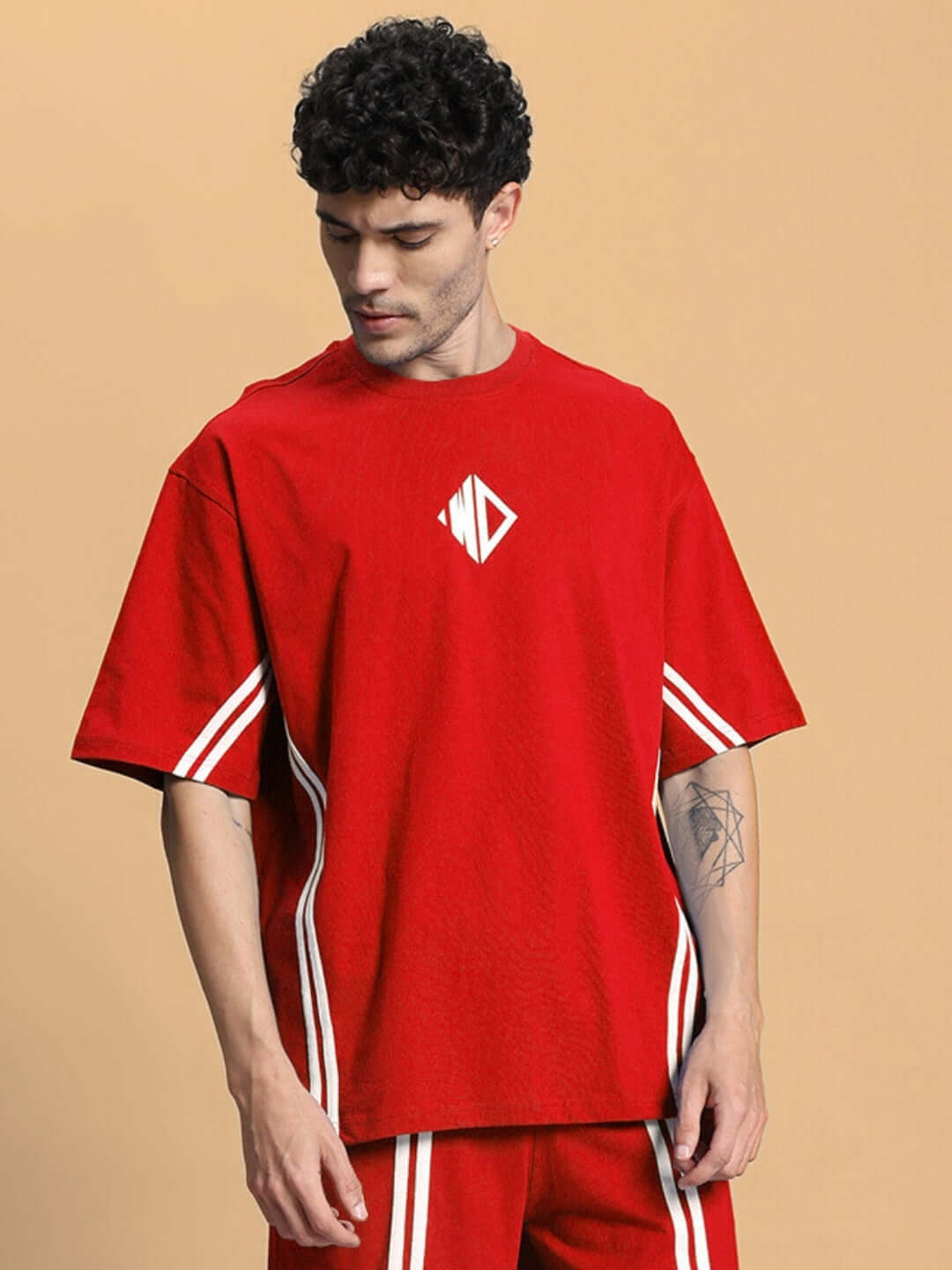 Model wearing OUTLOOK OVER-SIZED T-SHIRT RED with white stripe accents, offering a soft and relaxed fit for modern casual style.