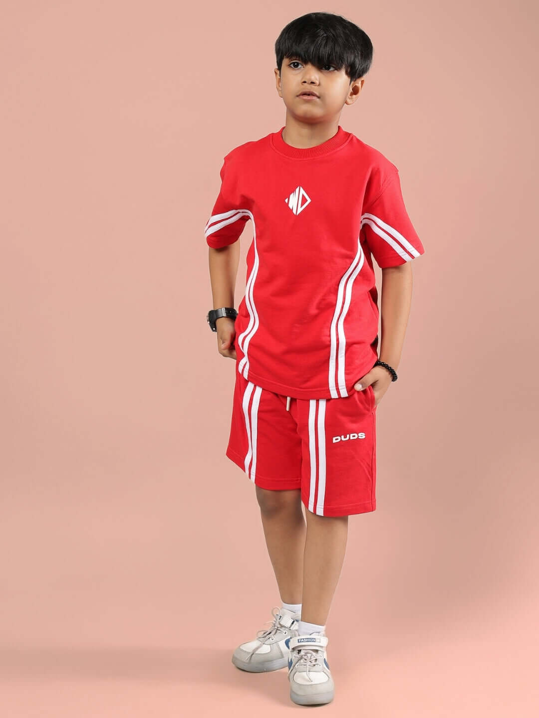 Child wearing red Outlook Half Co-ord set by DUDS, featuring striped accents, perfect for boys and girls. Tailored for custom fit.