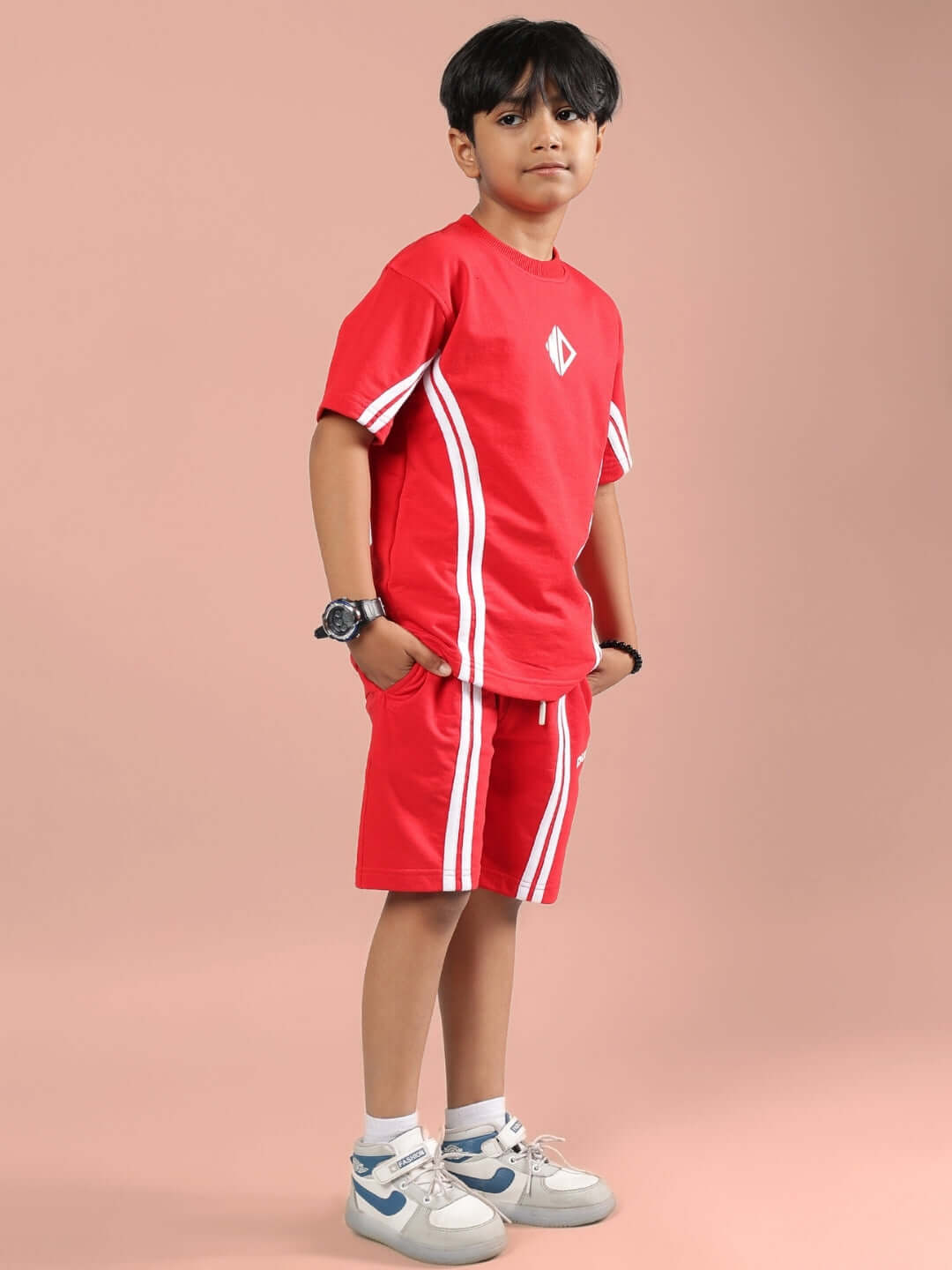 Child wearing red Outlook Half Co-ord set for boys and girls, featuring white stripes, designed by DUDS, available in custom fit.