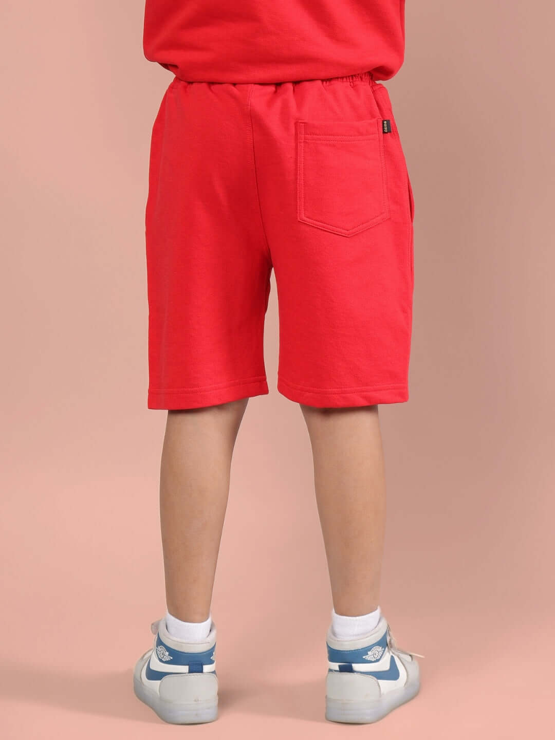 Child wearing OUTLOOK SHORTS FOR BOYS GIRLS RED, showcasing comfortable and stylish design suitable for everyday and active wear.