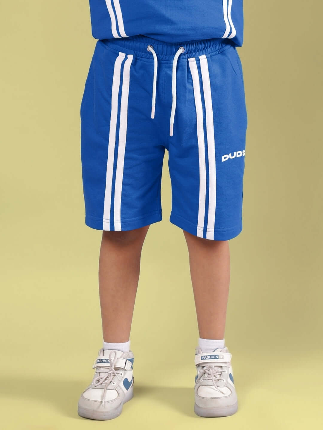 Child wearing OUTLOOK SHORTS FOR BOYS GIRLS BLUE, showcasing comfortable and stylish activewear.