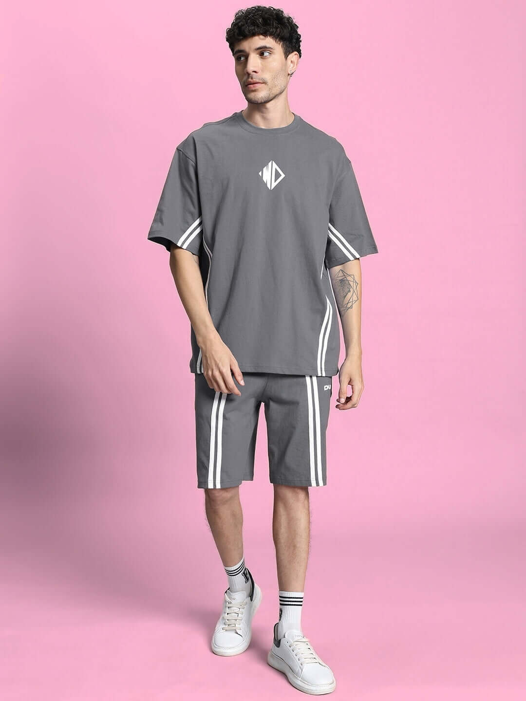 Man wearing OUTLOOK SUMMER CO-ORD SHORTS SET GREY with sleek modern design on pink background