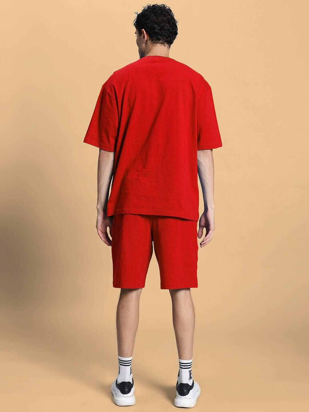 Rear view of model wearing OUTLOOK SUMMER CO-ORD SHORTS SET RED, showcasing vibrant style in casual tee and shorts, perfect for summer.
