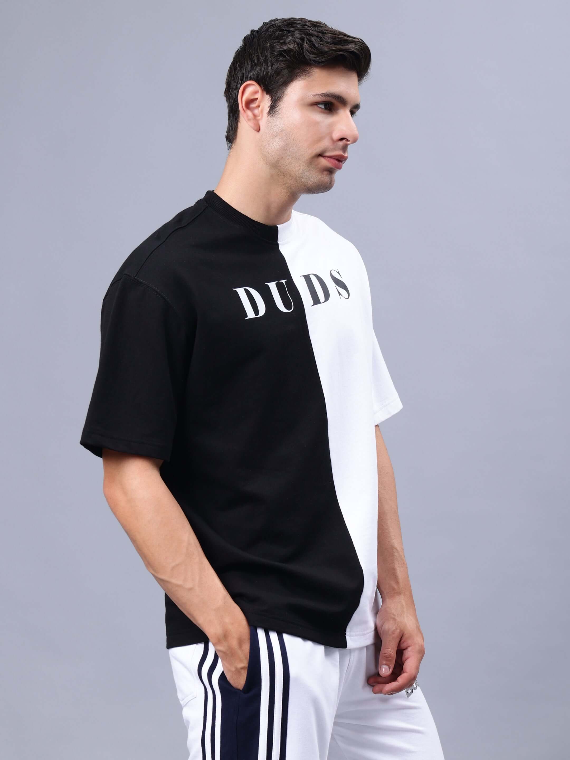 Man wearing G.O.A.T oversized black-white t-shirt made of premium cotton, styled with French terry fabric, India origin.