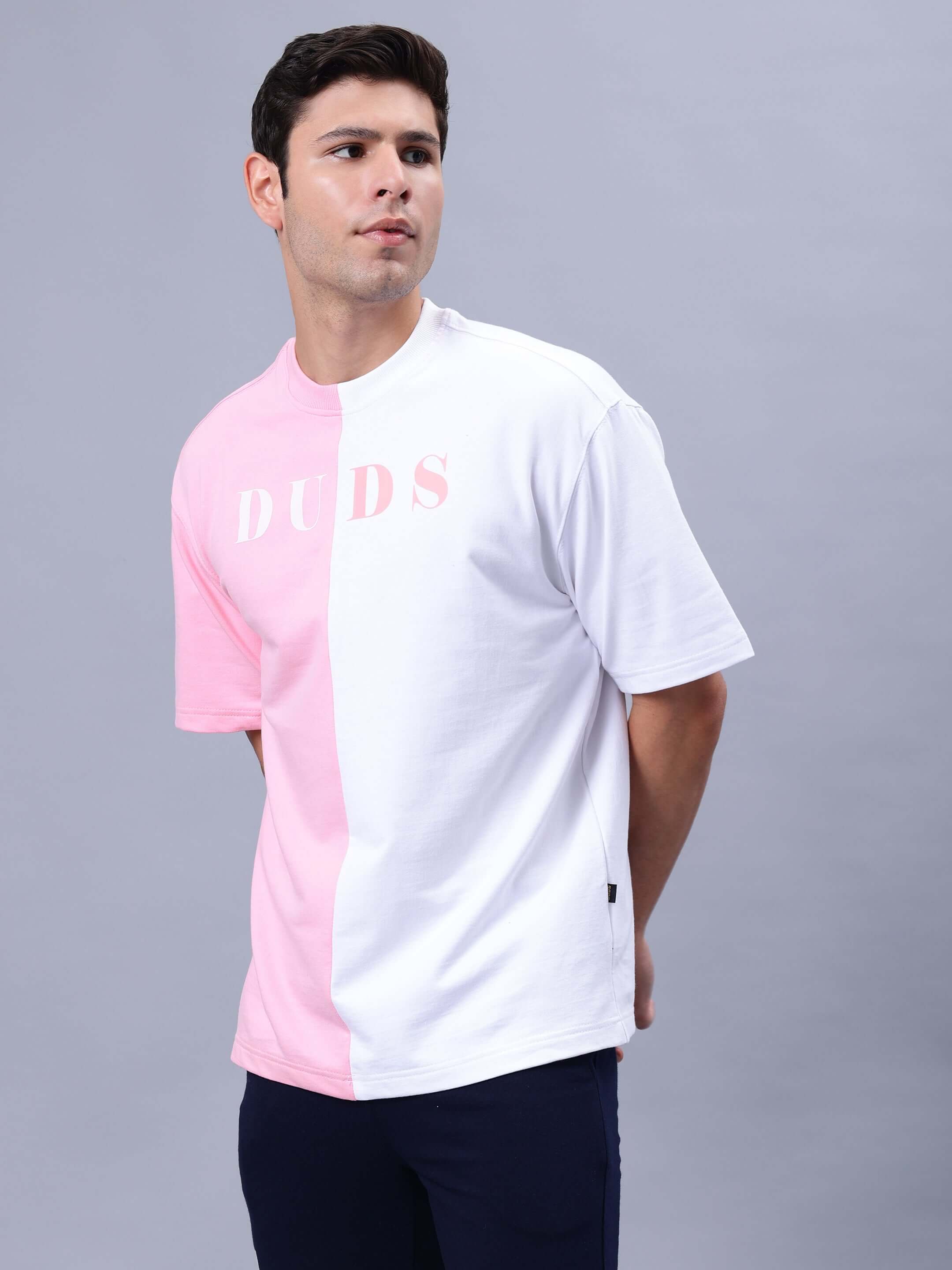Model wearing G.O.A.T oversized pink-white t-shirt, premium cotton fabric, India made, bio-washed, for casual wear