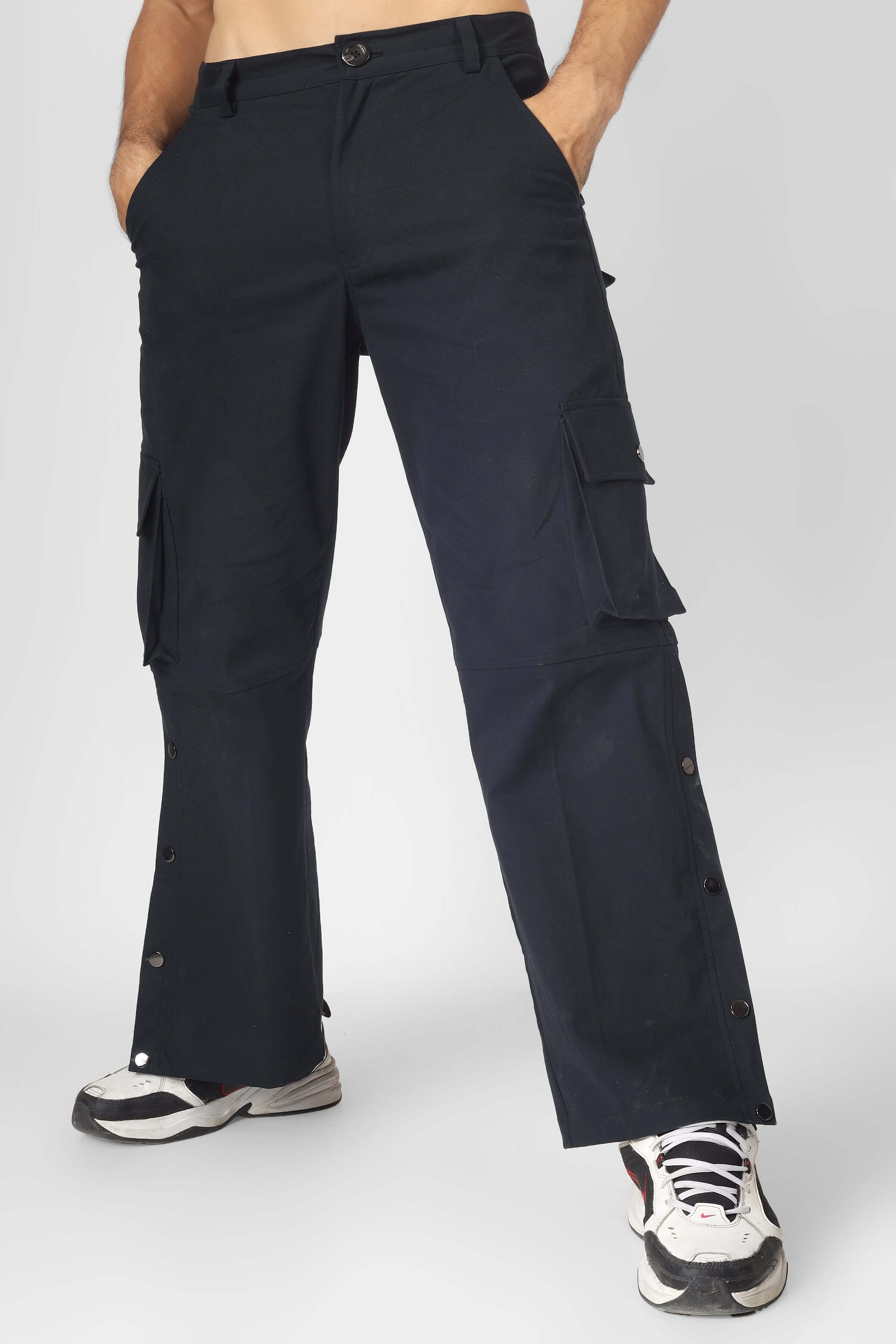Person wearing Oxford blue cargo pants with six pockets, made by DUDS, paired with sneakers. Available for custom fit orders, 7-10 days dispatch.