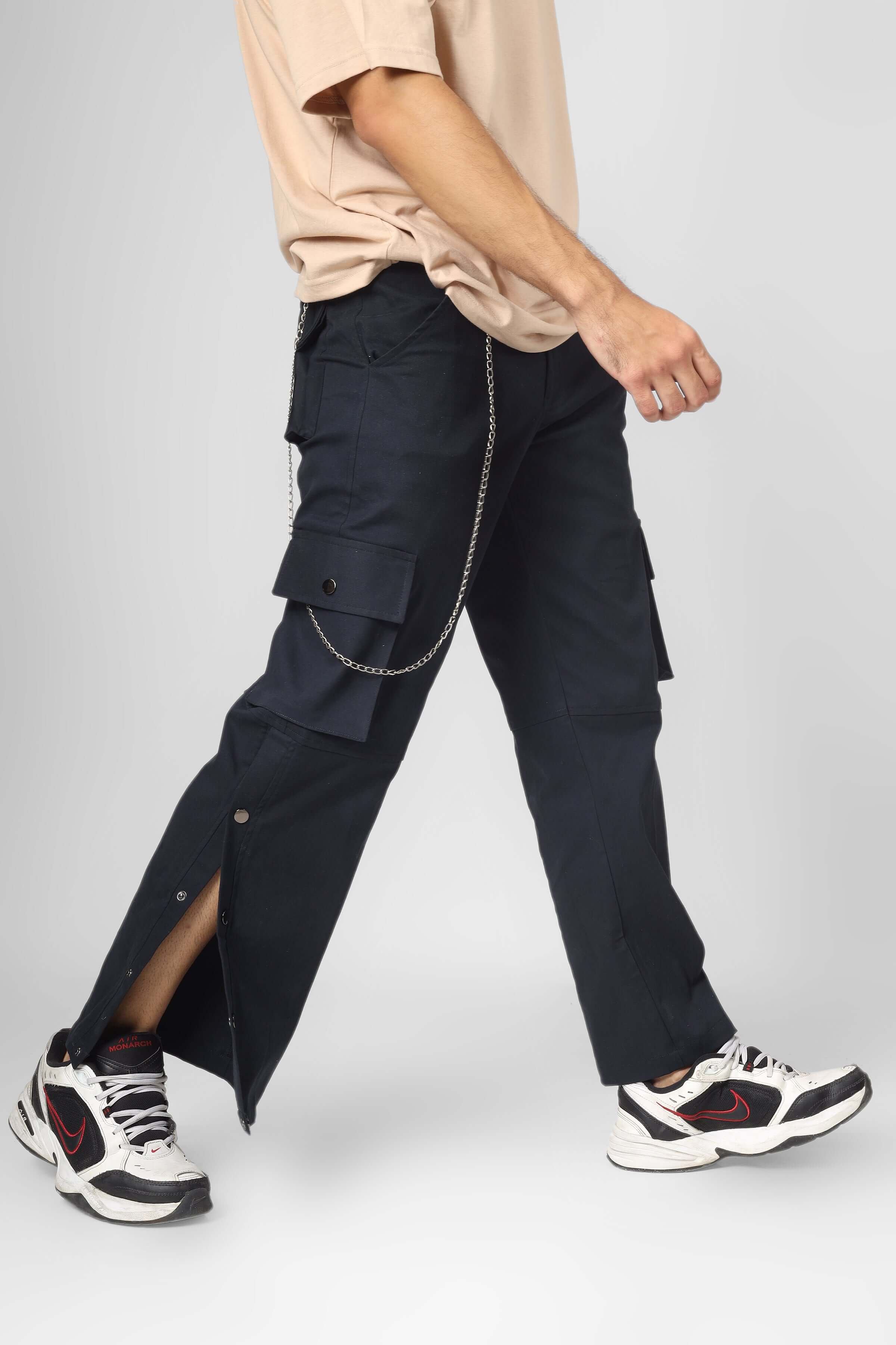 Person wearing oxford blue cargo pants with six pockets and sneakers, showcasing streetwear fashion style.