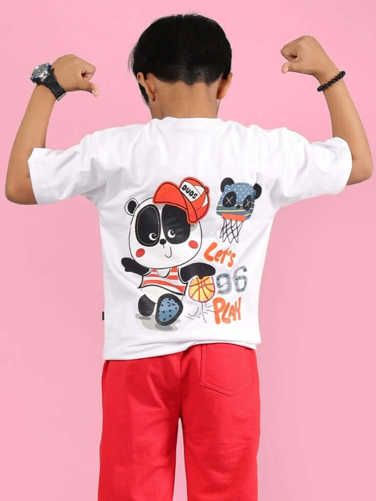 Child flexing in white PALOMA T-shirt with panda basketball design, red pants; unisex made-to-order by DUDS with custom fit options available.