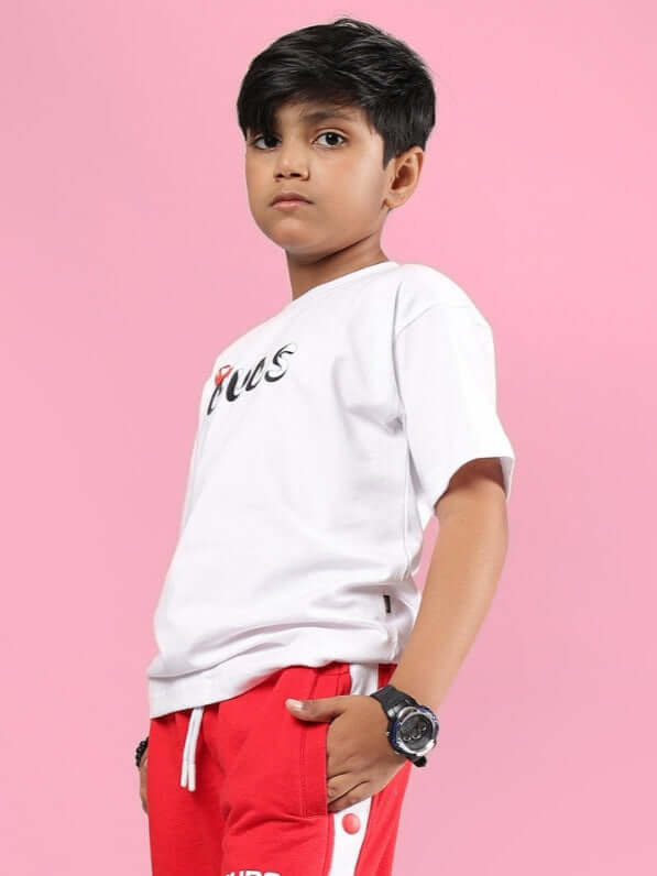 Young model wearing a white Paloma T-Shirt from DUDS, available for boys and girls, with customizable fit options.