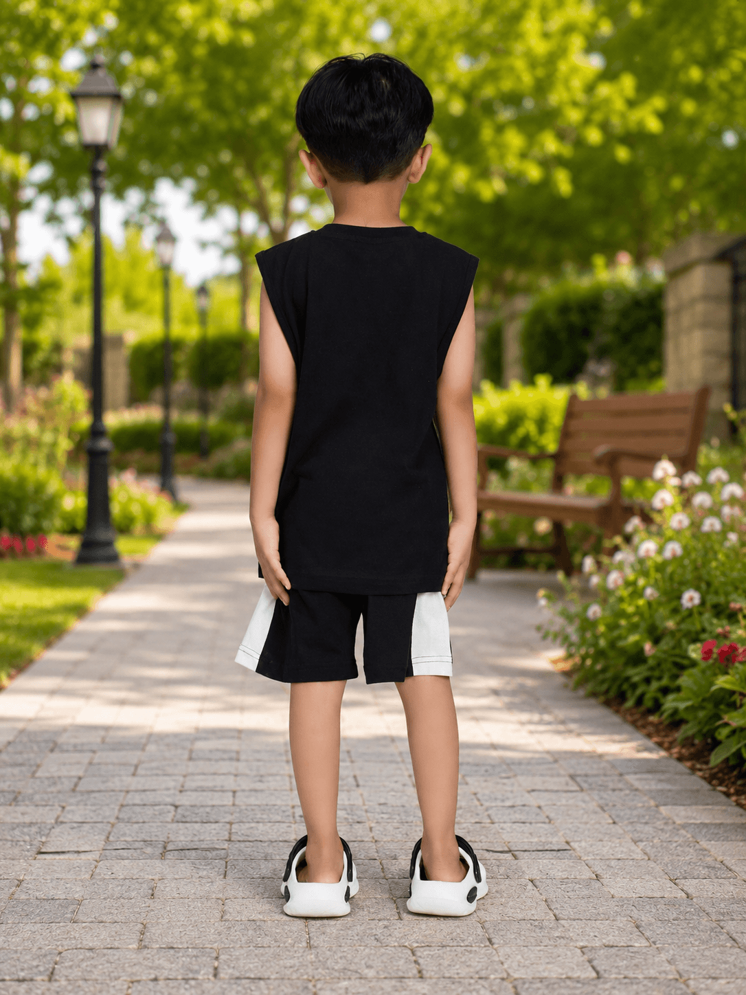 PANDA POP SLEEVELESS CO-ORD FOR BOYS GIRLS BLACK WHITE shown on a child from behind in a park setting.