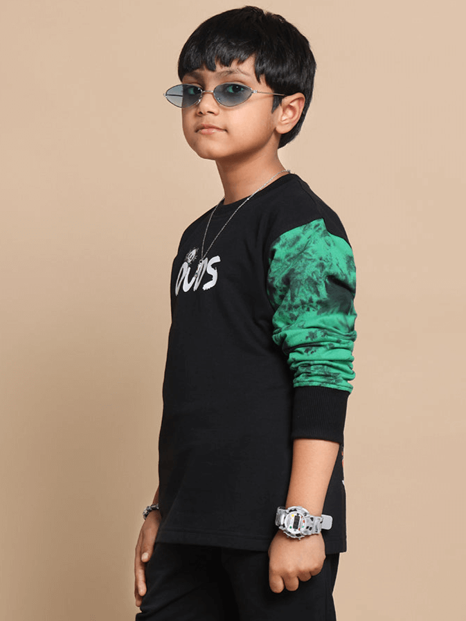 Boy wearing black oversized panda sweatshirt with green sleeve and sunglasses, showcasing DUDS custom fit option.