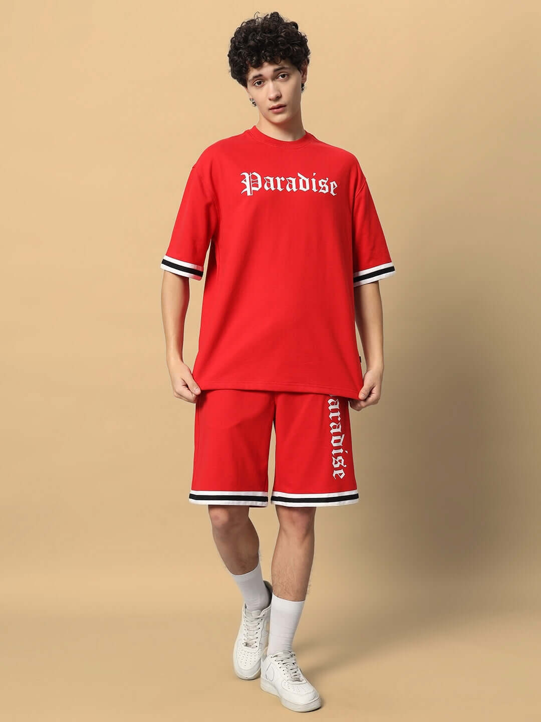 Model wearing Paradise red colorblock co-ord set made of premium cotton French terry lycra, features shorts and t-shirt, stylish and comfortable.