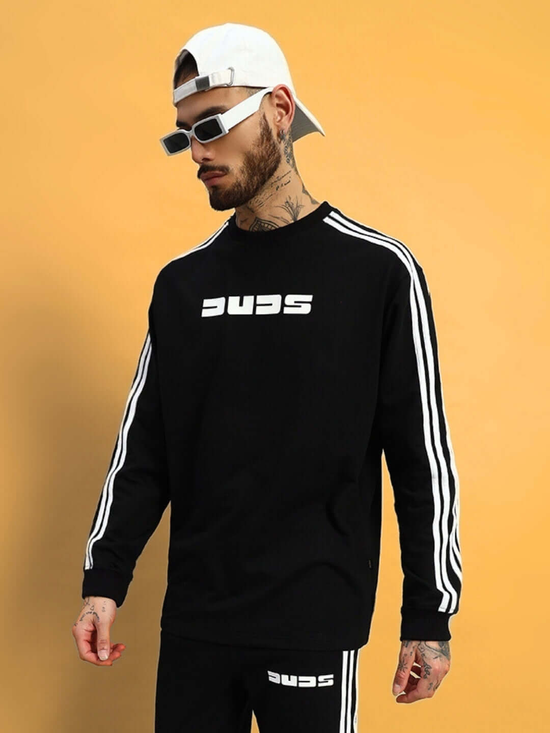 Model wearing oversized black parka sweatshirt with white stripes, featuring premium cotton fabric, perfect for casual wear