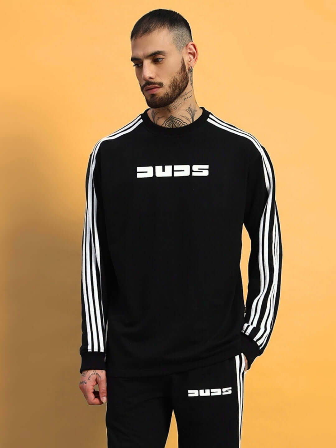 Model wearing black oversized sweatshirt with white stripes, made of premium cotton French terry lycra for comfort and style.