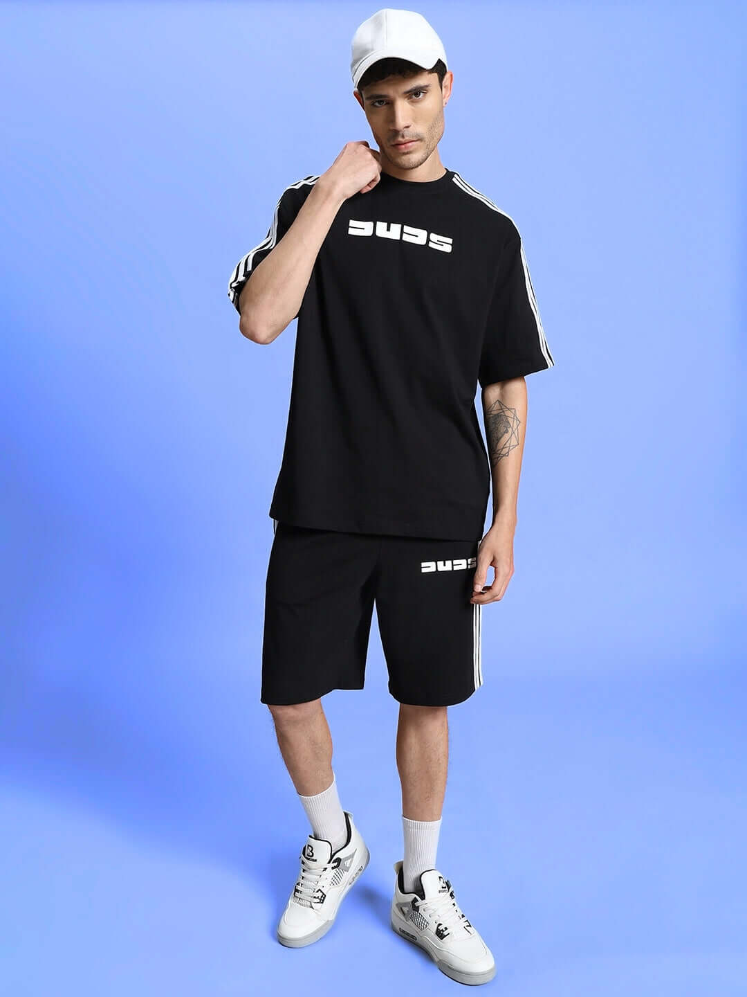 Model wearing PARKA REGULAR FIT SHORTS BLACK with matching t-shirt and sneakers, showcasing a stylish and comfortable look.