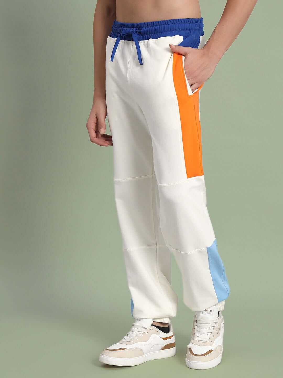 Model wearing Parker Side Contrast Joggers in off-white with blue and orange accents, showcasing stylish and customizable design.