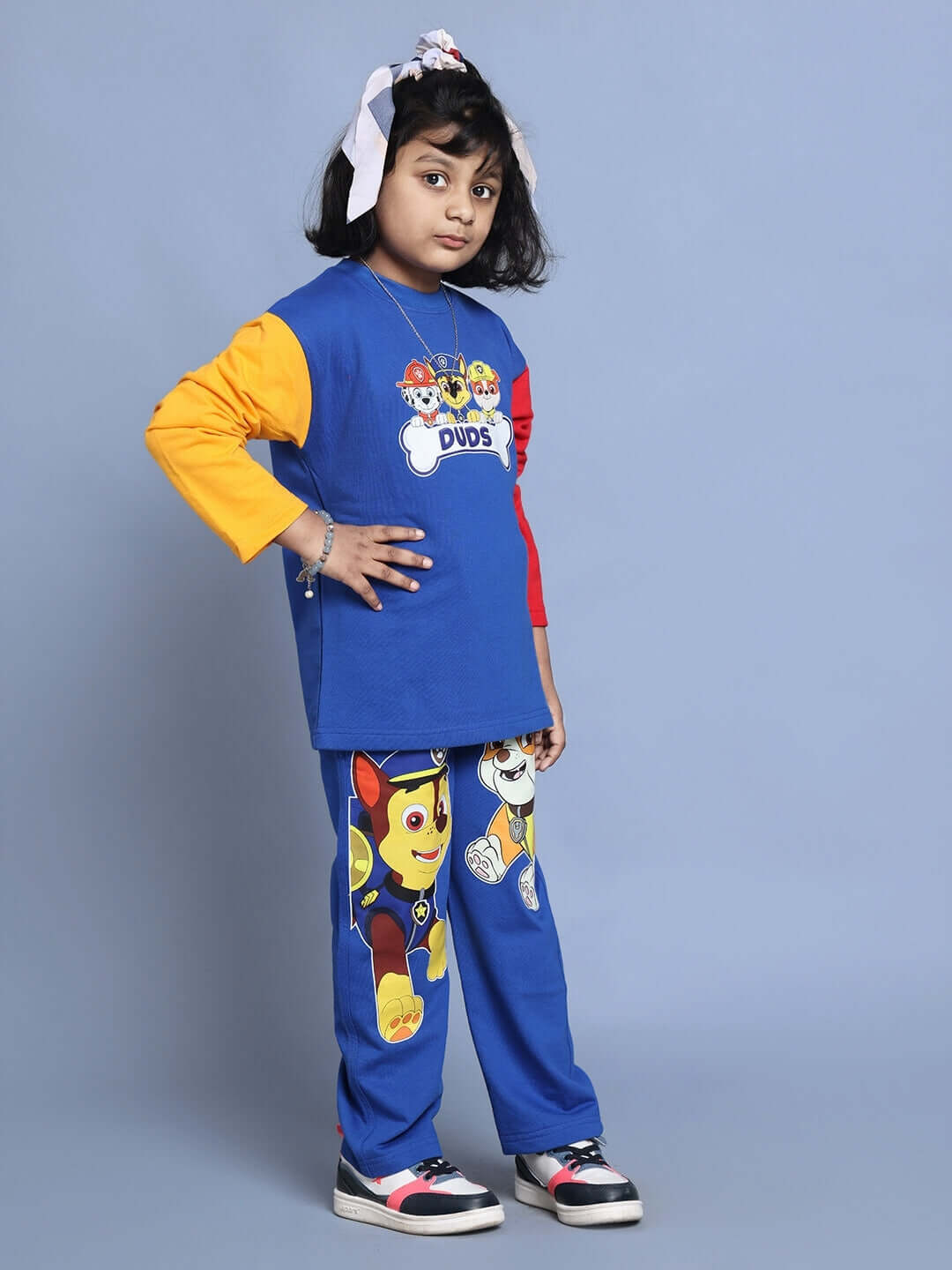 Child wearing Paw Patrol oversized co-ord set in blue with colorful sleeves, featuring cartoon characters on joggers, perfect for boys & girls.