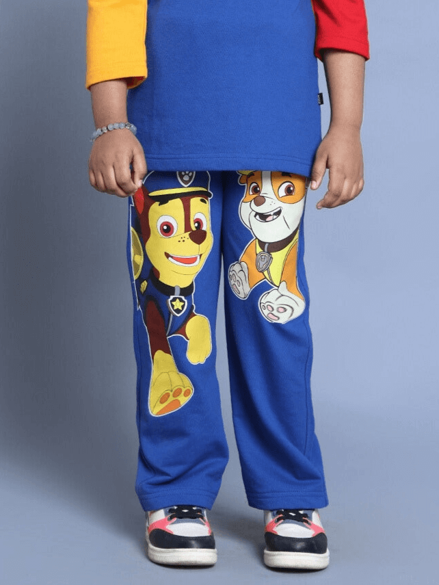 Child wearing blue Paw Patrol relaxed jogger pants featuring character prints, ideal for boys and girls. Custom fit available.