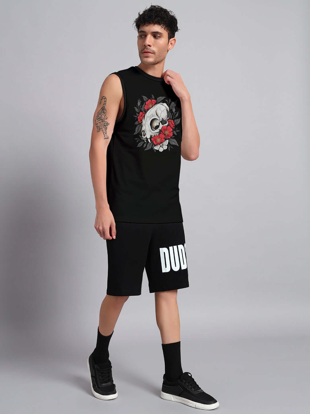 Man wearing PEONIES SKULL CO-ORD SET BLACK with bold skull and peony design on black backdrop.