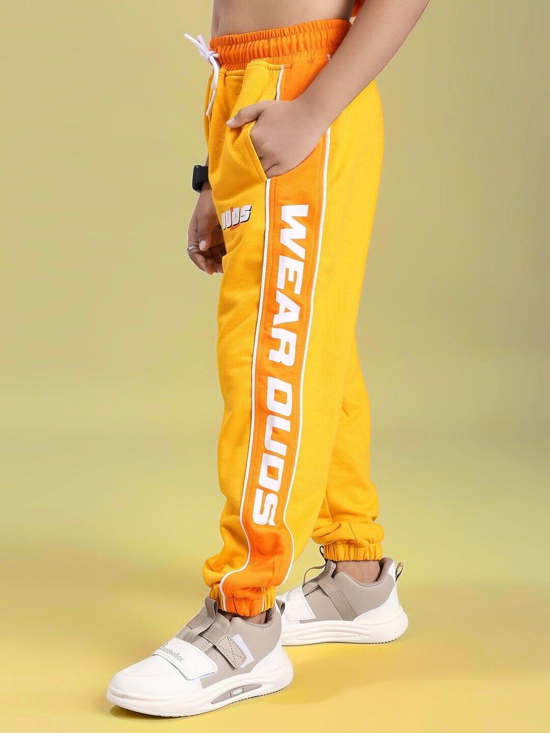 Child wearing PEPPY JOGGER FOR BOYS AND GIRLS ORANGE showing side view with vibrant color and comfortable fit.