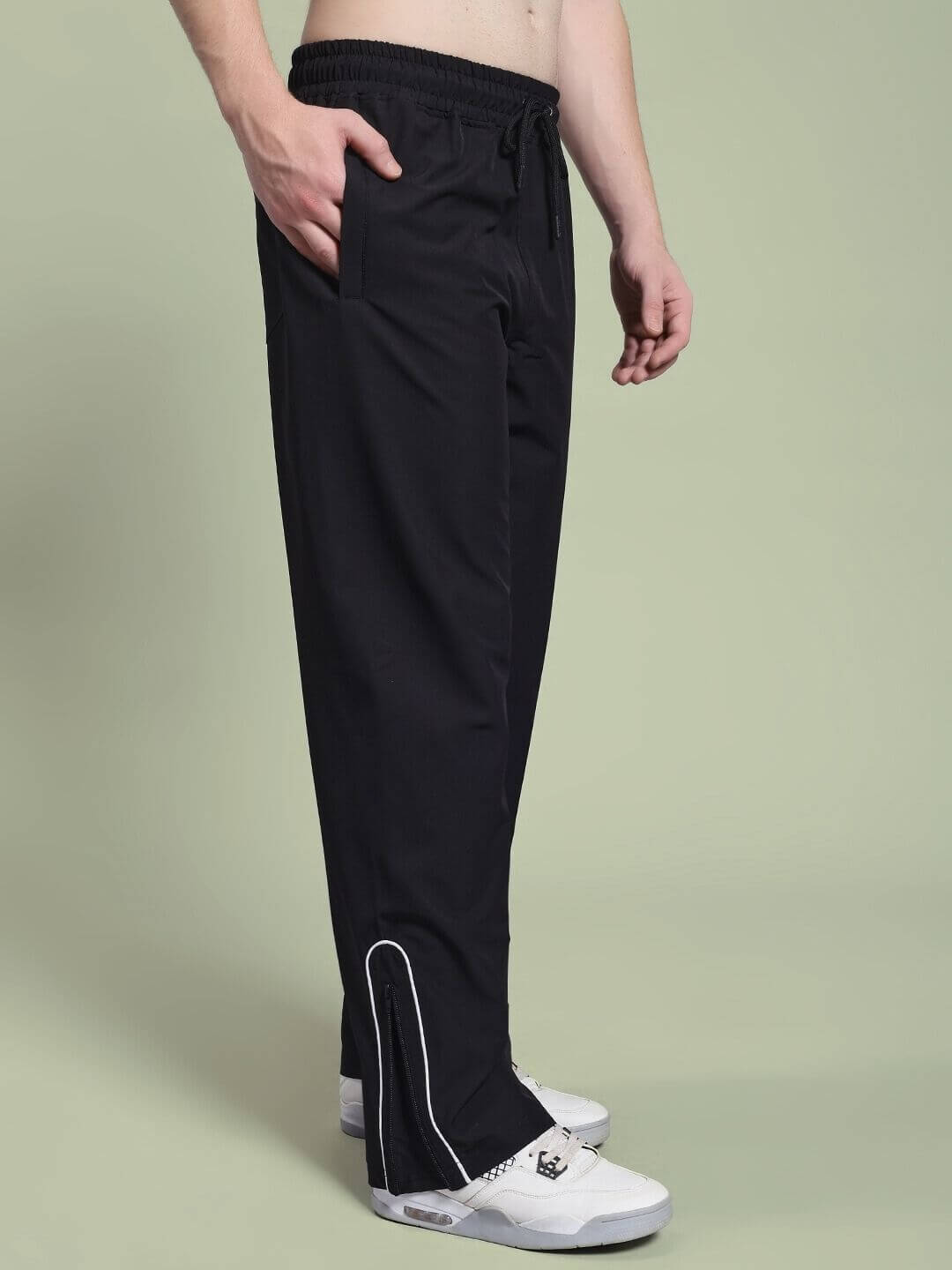 Side view of man wearing PERFACT RELAXED-FIT JOGGER BLACK with white sneakers, showcasing casual and comfortable style