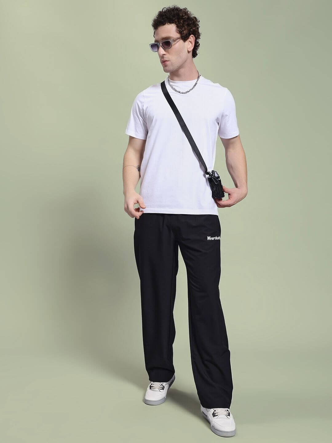 Model wearing PERFACT RELAXED-FIT JOGGER BLACK with white t-shirt and sunglasses.