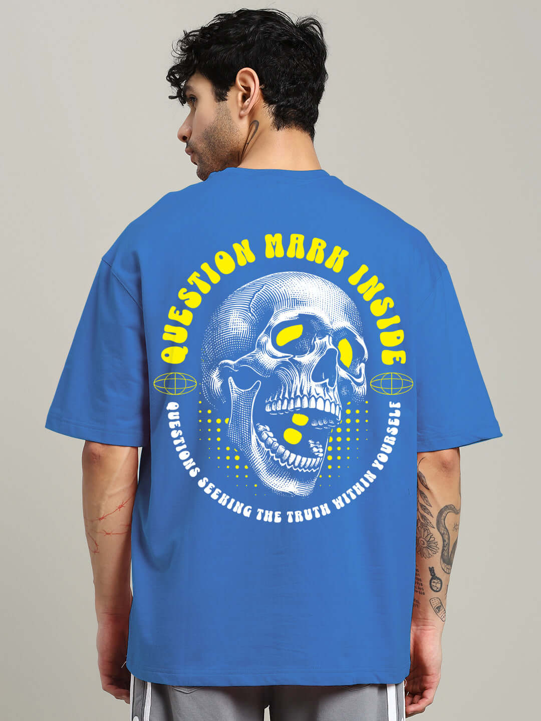 Back view of a blue oversized t-shirt with skull and text design, featuring premium heavy gauge fabric made from 97% cotton and 3% elastane.