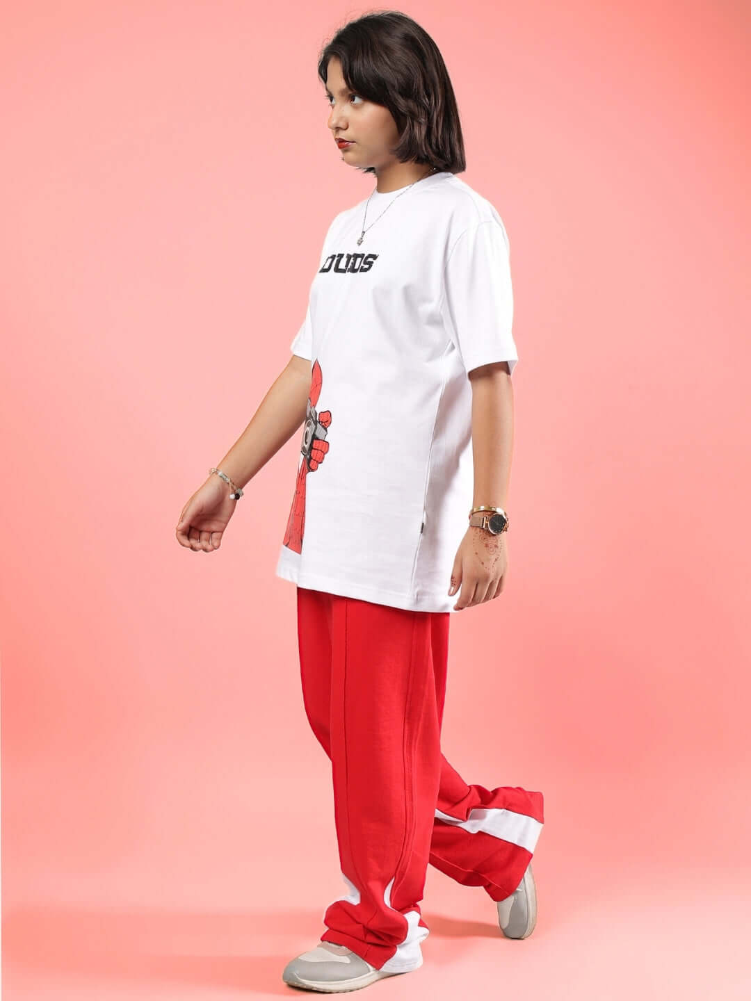 Child wearing PETER CO-ORD FOR BOYS & GIRLS WHITE-RED outfit from DUDS, made to order with custom fit option, standing on pink background.