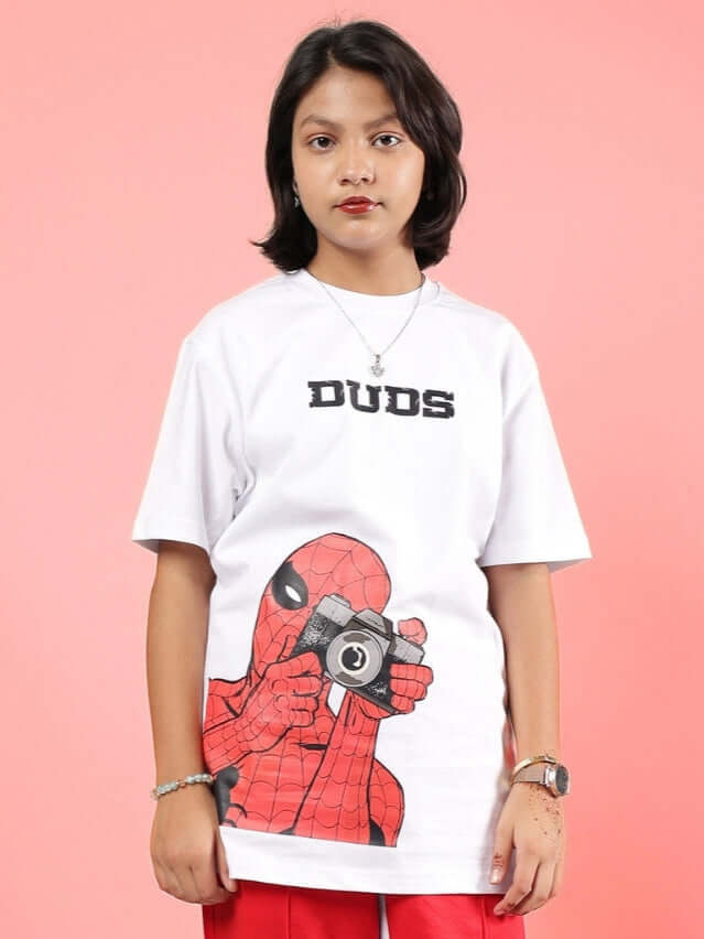 Child wearing a white Peter T-shirt for boys girls white with a superhero camera print and the word 'DUDS' on the chest.