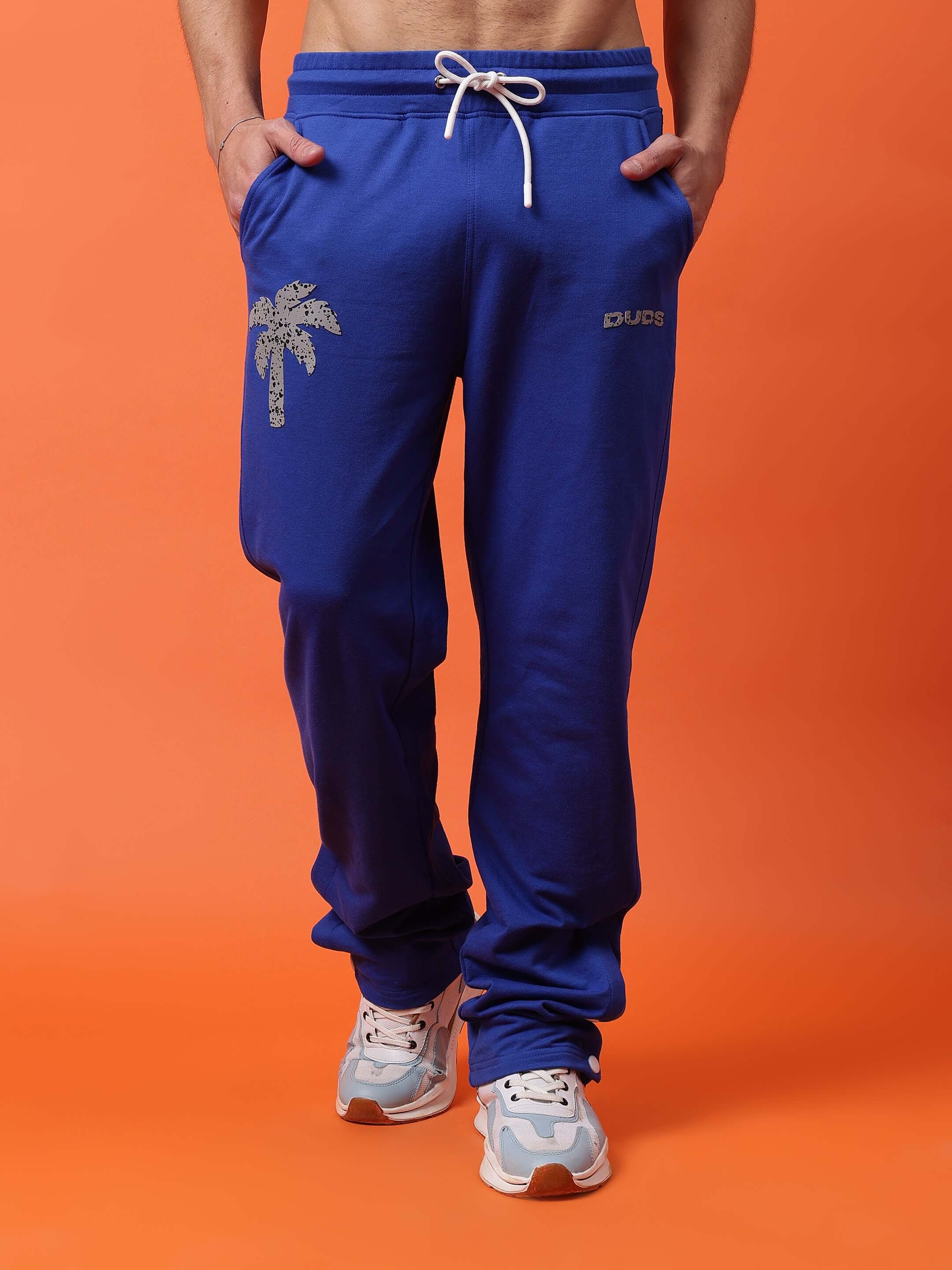 Royal blue digital printed joggers by DUDS featuring a palm tree design, perfect for casual style. Custom fit available for prepaid orders.
