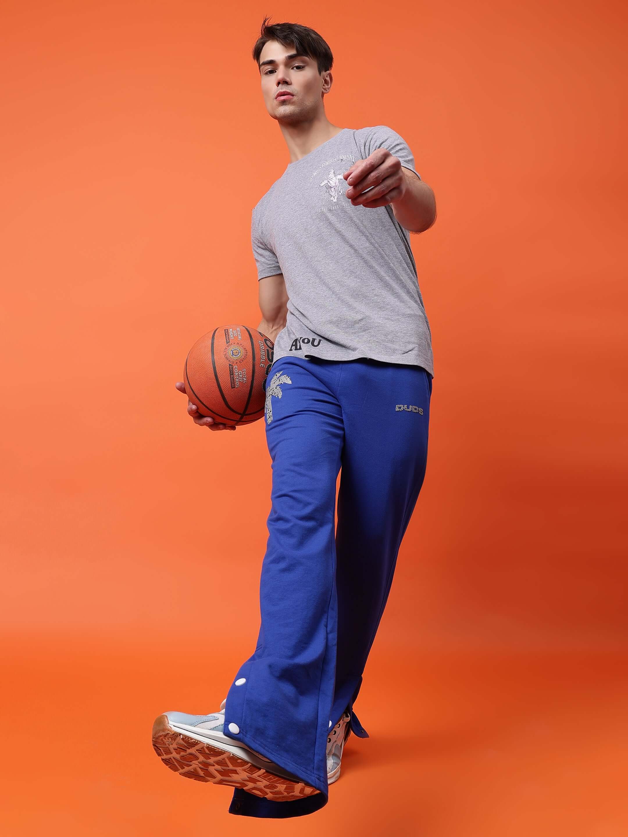 Model wearing Phoenix Digital Printed Joggers in Royal Blue holding basketball, showcasing sporty and stylish comfort.