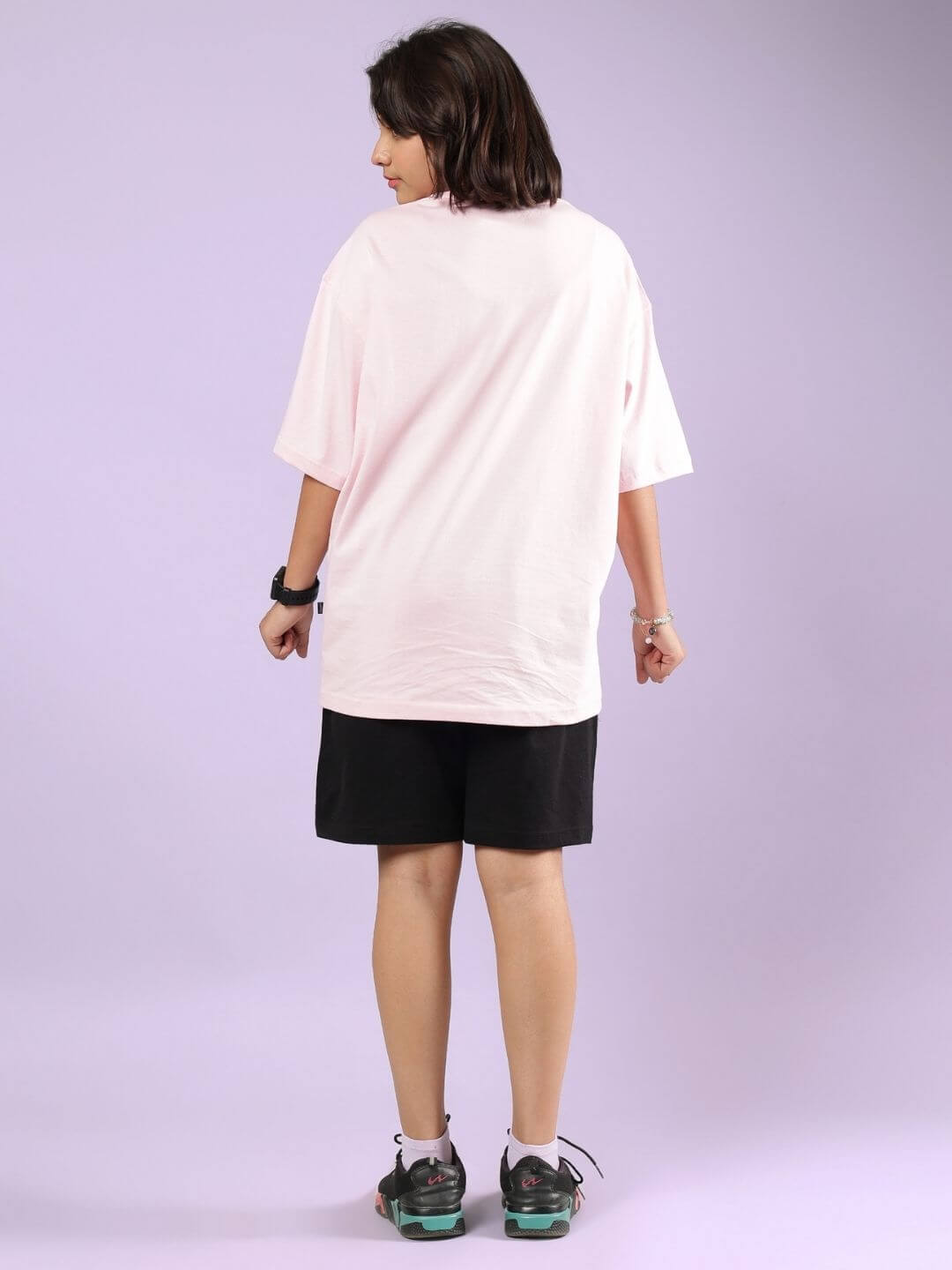 Child wearing a pink and black co-ord set, consisting of a relaxed-fit top and shorts, perfect for play and comfort.