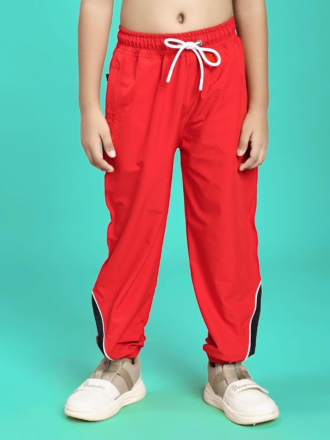 Child wearing PLEXUS JOGGER FOR BOYS AND GIRLS RED with adjustable drawstring, ideal for active play and casual outings.