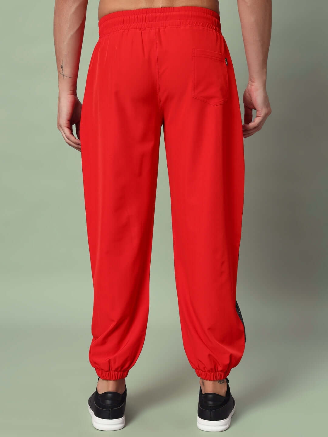 Red Plexus joggers by DUDS, rear view, showcasing elastic waistband and tailored fit, available with custom sizing.