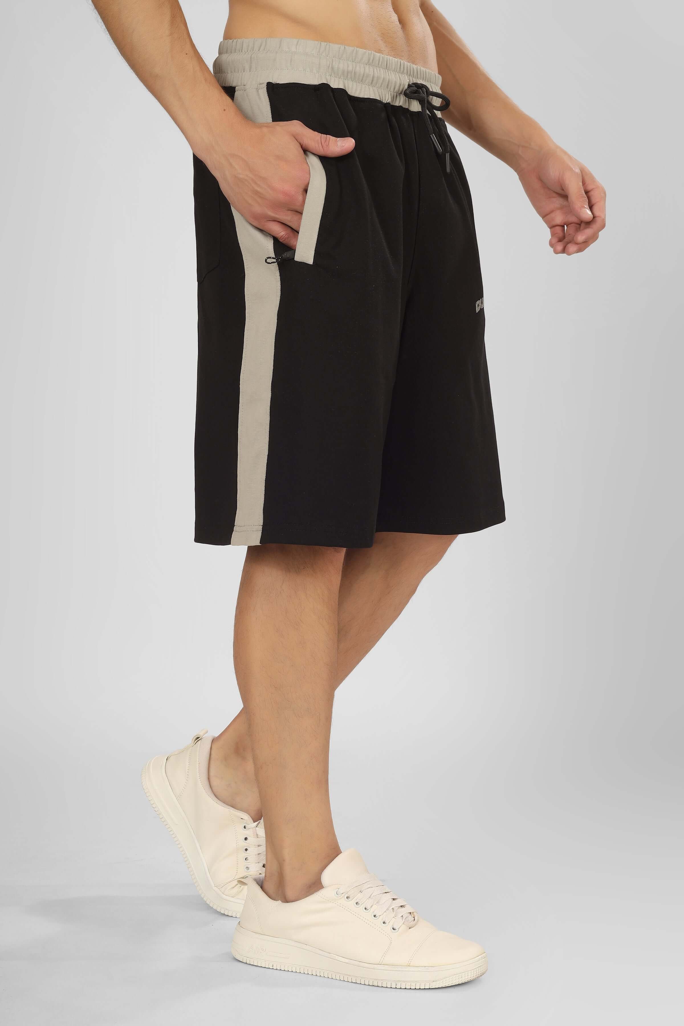 Model wearing Pluto Contrast Regular Fit Black Shorts with custom fit option, featuring a stylish side stripe design.
